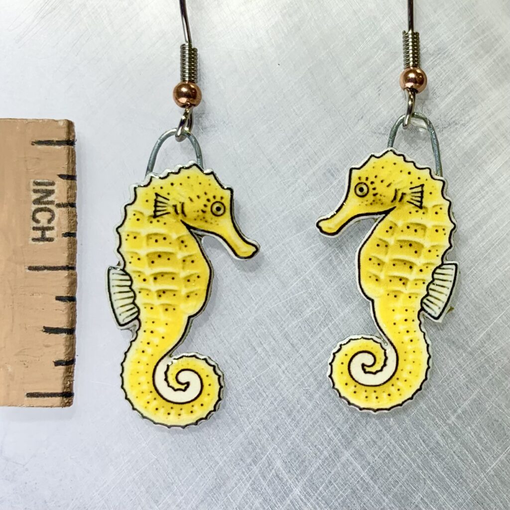 Picture shown is of 1 inch tall pair of earrings of the marine animal the Yellow Seahorse.