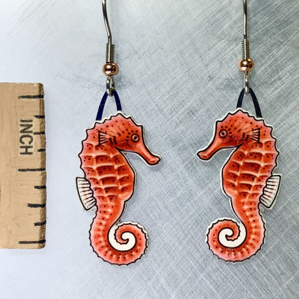 Picture shown is of 1 inch tall pair of earrings of the marine animal the Red Seahorse.