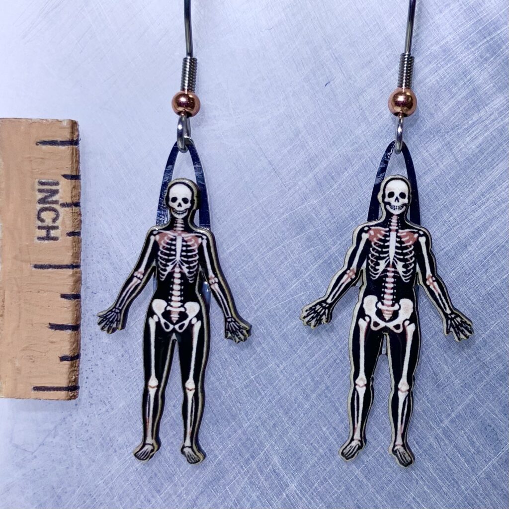 Picture shown is of 1 inch tall pair of earrings of Human Skeletons.